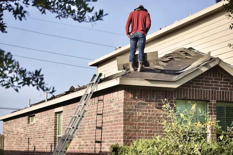Professional roofer working on a residential roof in Peterborough